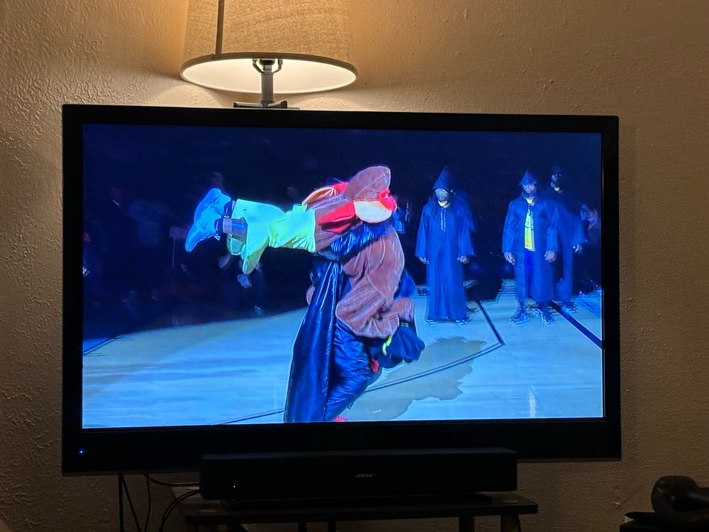 Griz mascot winding up a piledriver