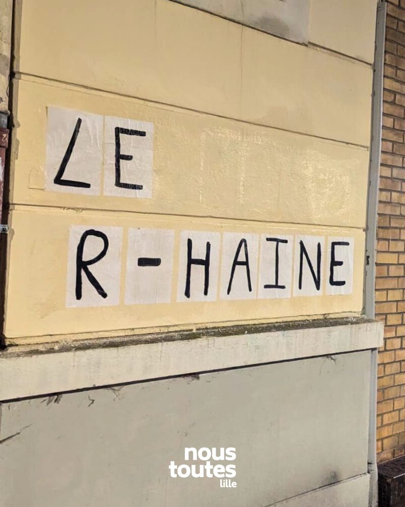 Collage sur un mur beige « LE R-HAINE » 