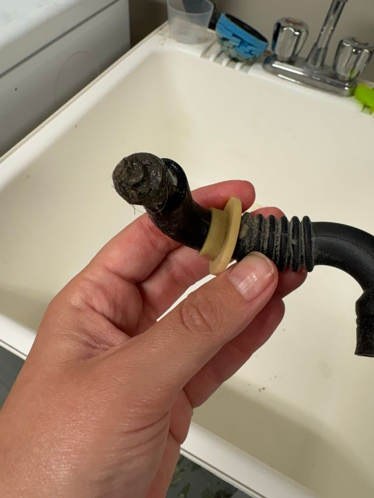 A clogged tub drain hose from a front load washing machine