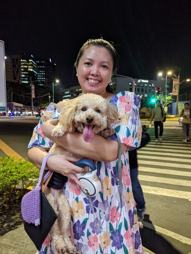 A Tagalog woman rocking a floral dress and carrying a cute puppy called Aegon!