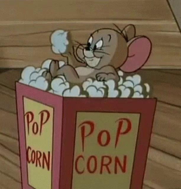 jerry from tom and jerry is sitting in a box of pop corn