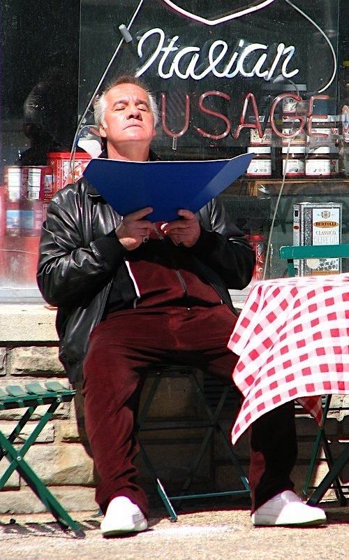 Paulie Walnuts tanning in front of the pork store