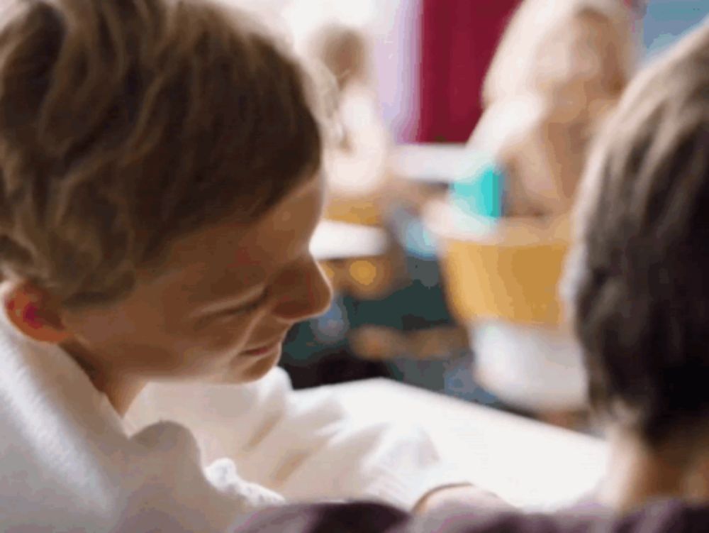 a boy and a girl are looking at each other