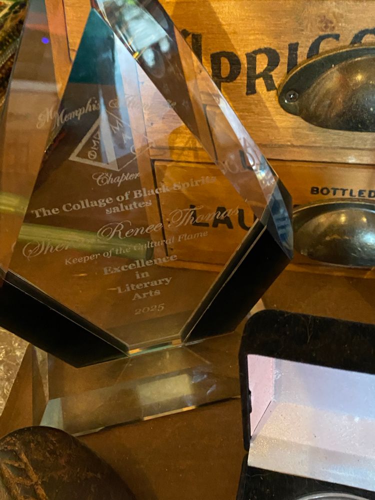 Glass, Diamond-shaped trophy award on a crystal base atop wood credenza 