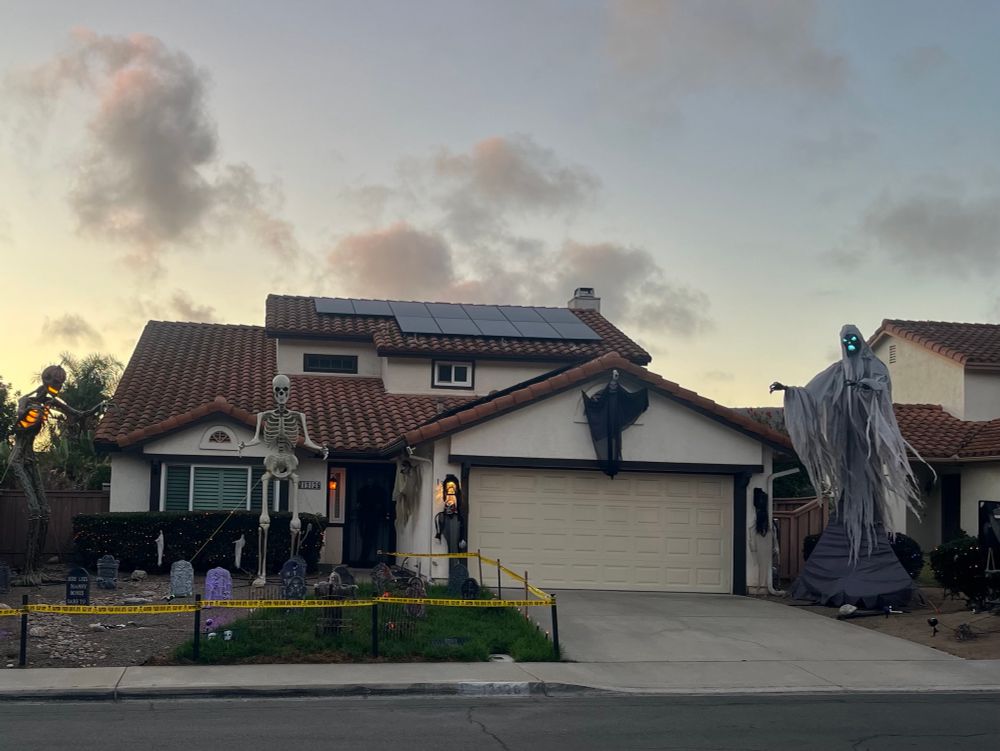 Yard with giant skeletons and a grim reaper plus headstones. It’s terrifying