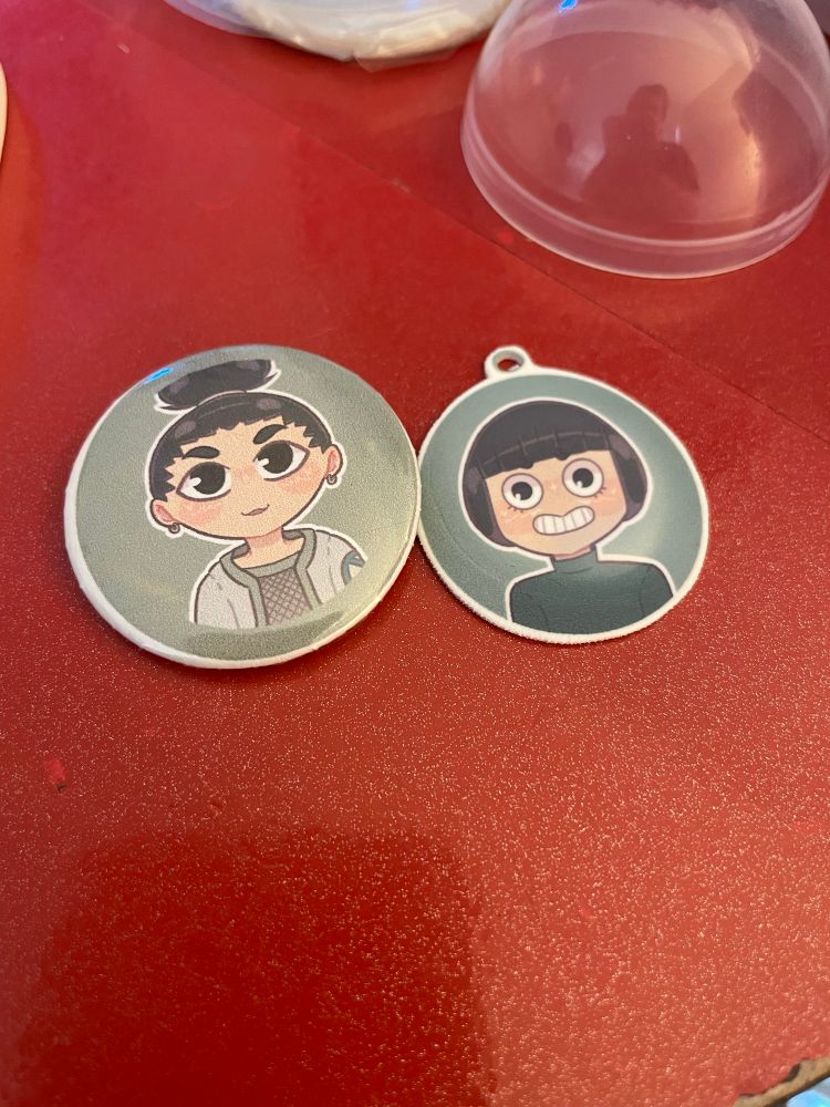 Shikamaru Nara as a button pin and Rock Lee as a part of a charm!