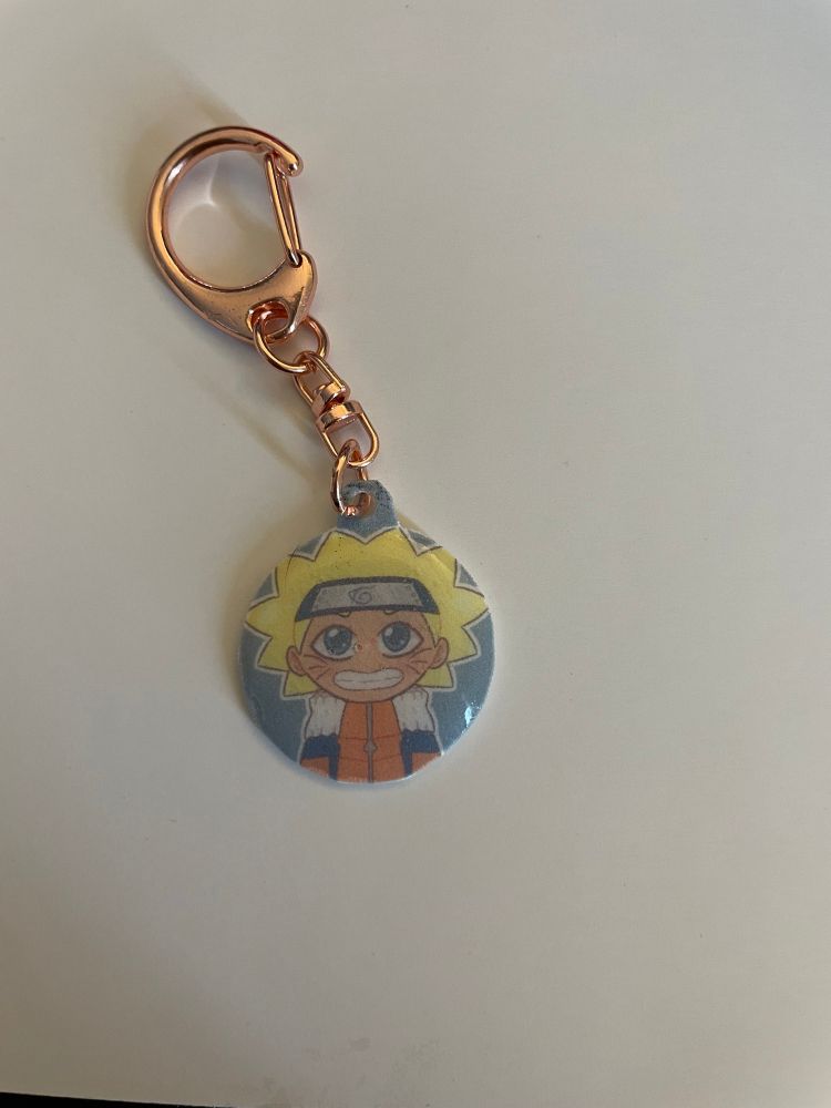 Finished charm for Naruto uzumaki- finished with resin and added a Clasp and rings.