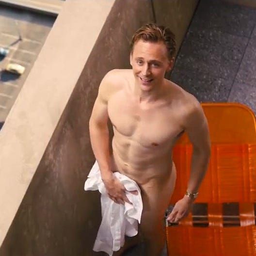 Tom Hiddleston in the movie High Rise is on the balcony naked and holds a towel to cover his manly bits