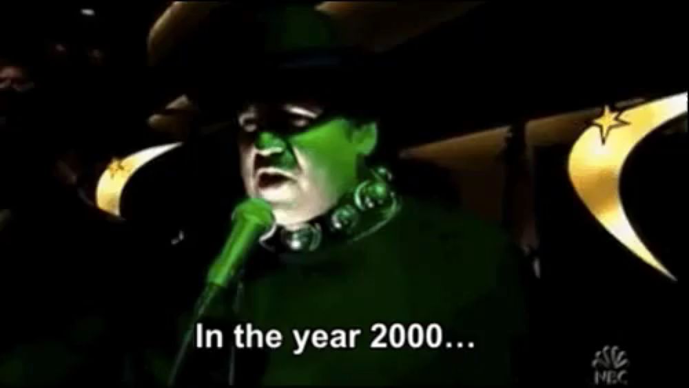 a green witch singing into a microphone with the words in the year 2000