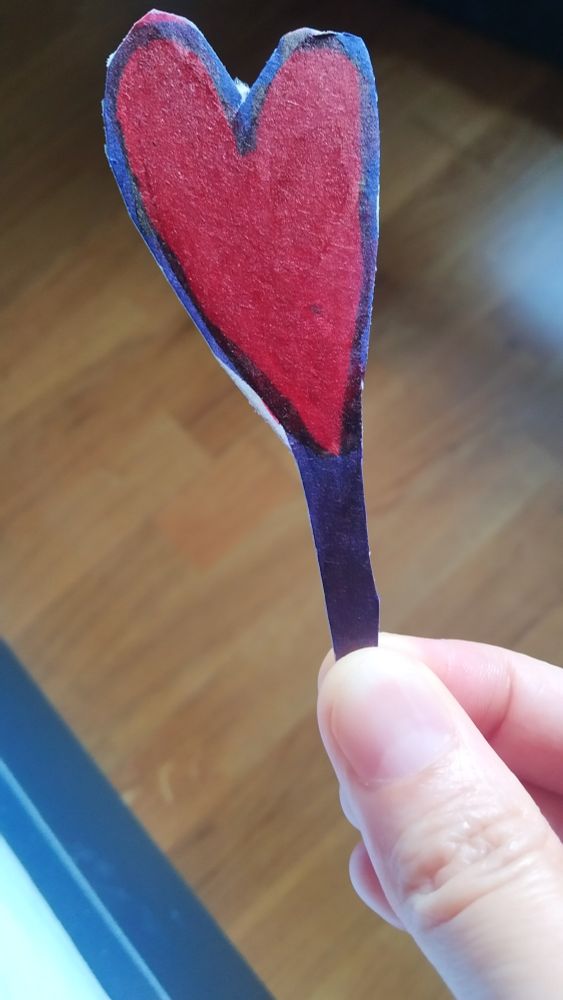 Piece of paper shaped as a heart and painted red