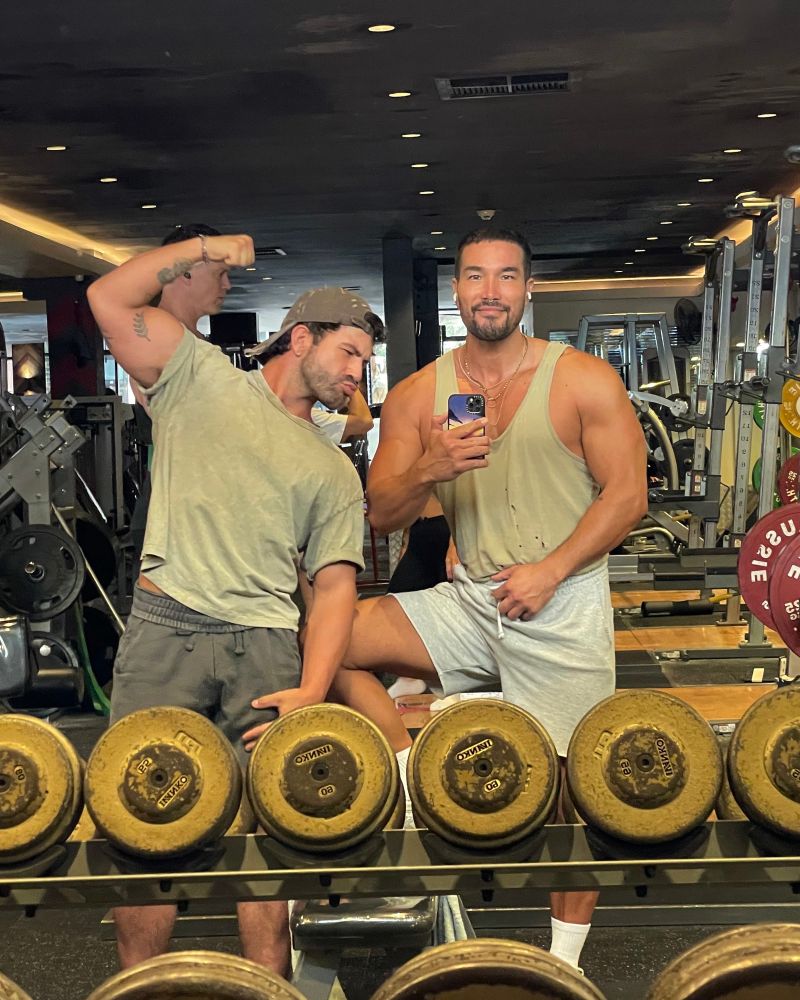 it’s two friends at the gym, and kenny is giving a bicep flex 