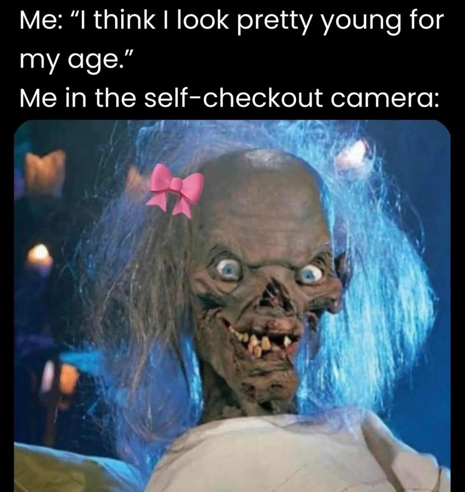 A humorous meme contrasts self-perception with reality. Top text: "Me: 'I think I look pretty young for my age.'" Bottom: "Me in the self-checkout camera:" shows a creepy, wide-eyed creature with disheveled hair and a pink bow, blending humor and sarcasm.