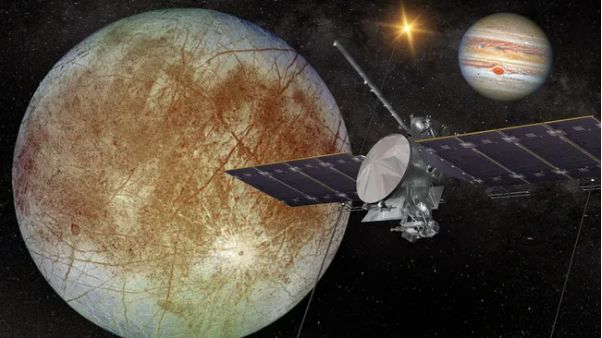 Artist depiction of Europa Clipper in space with Europa and Jupiter in background