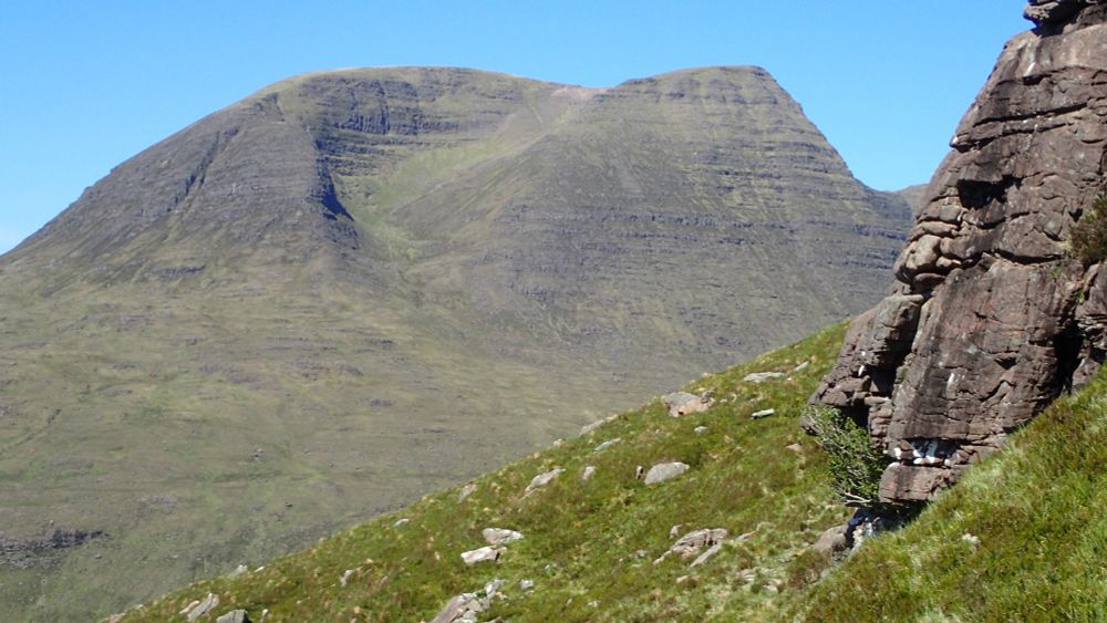 More basic outcrop (with holly) on right with Ben Alligin behind.