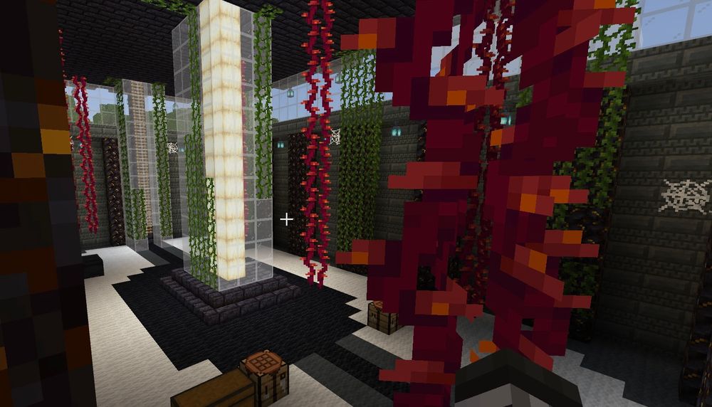 An interior look in the building’s first floor. Vines are growing everywhere (both the normal & red ones I don’t know the names of cause I’m a fake gamer). Theres also cobwebs, and the yellow beam from earlier is visible, protected in a glass casing.