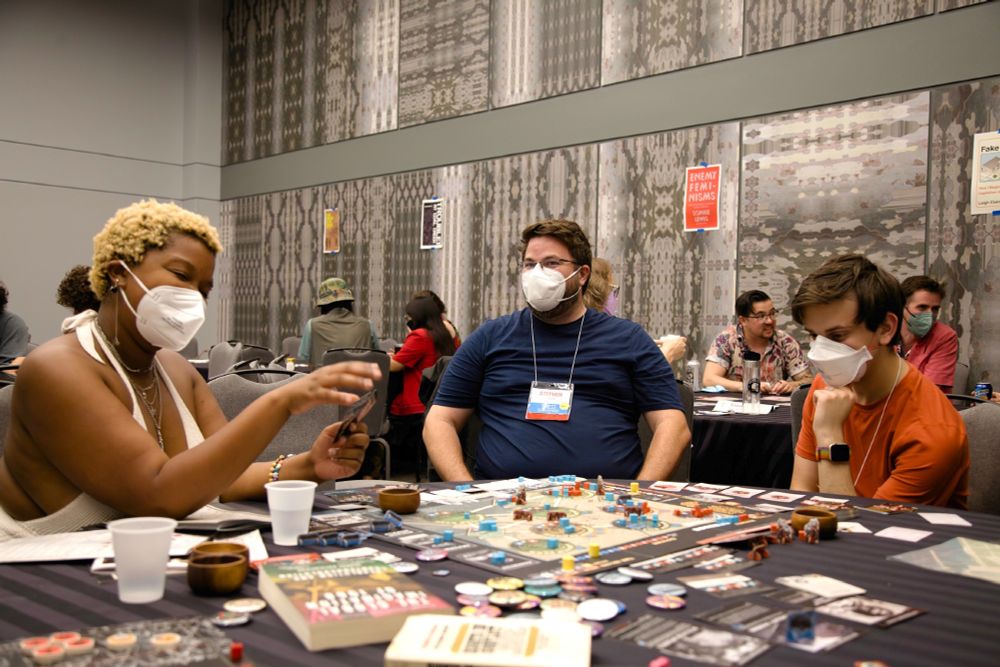 Players engaging with the board game, Chicago '68.