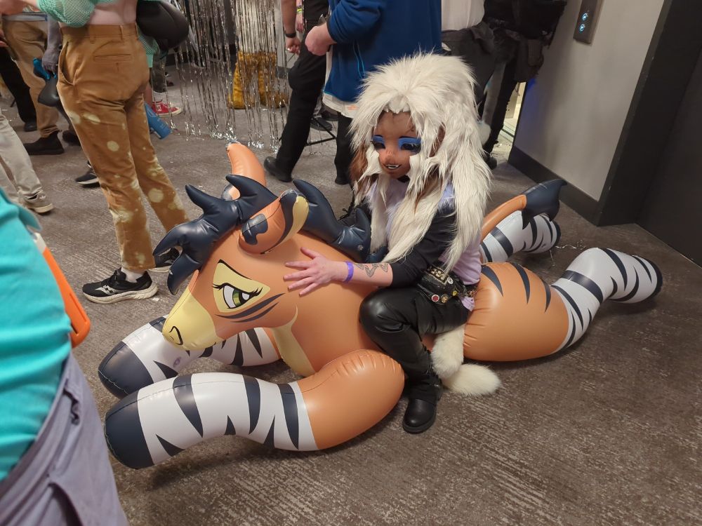 crema sitting on zoey the inflatable toy