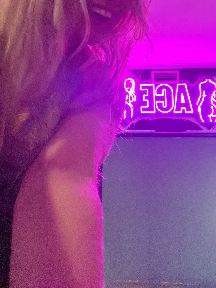 Luscious Lani posing under pink neon lights at Aces Gentleman’s Club in Tuggerah NSW 