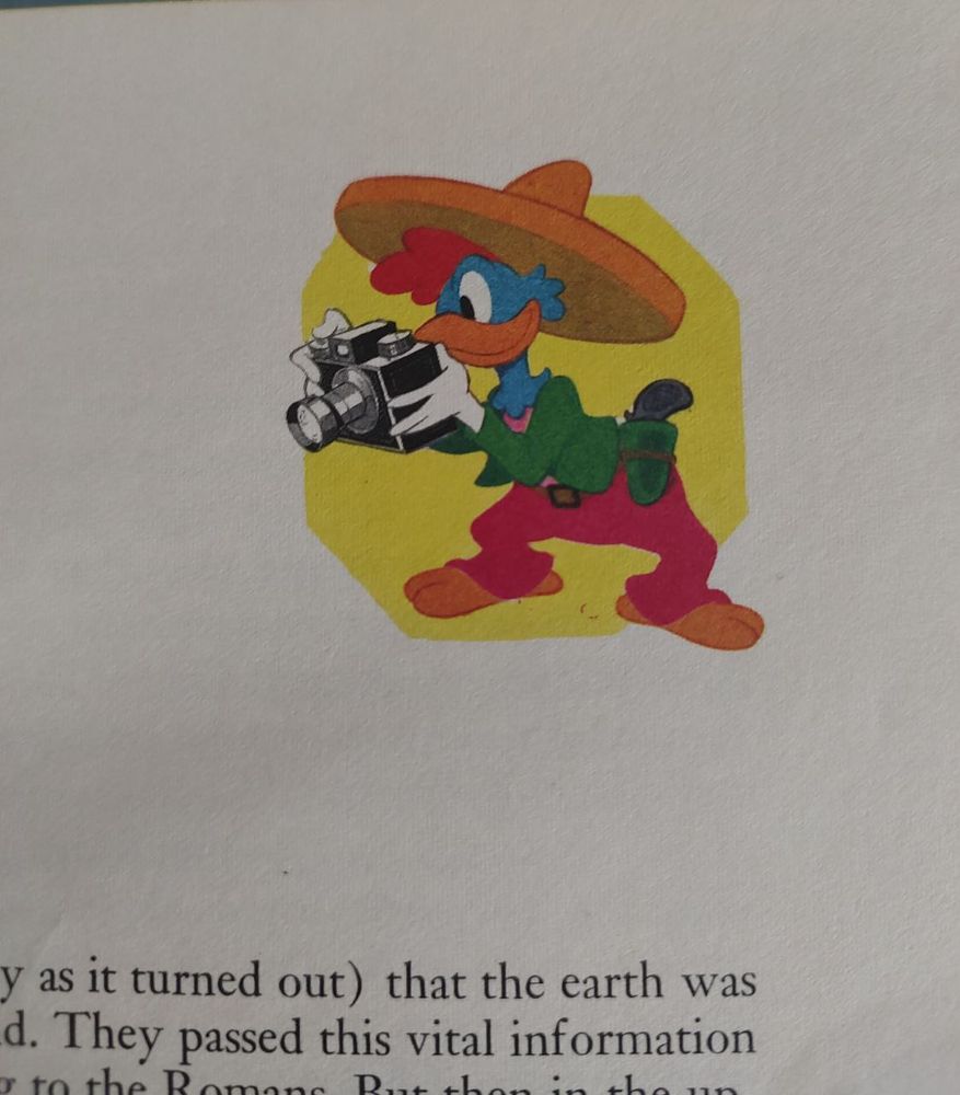 Panchito Pistoles holding a camera.