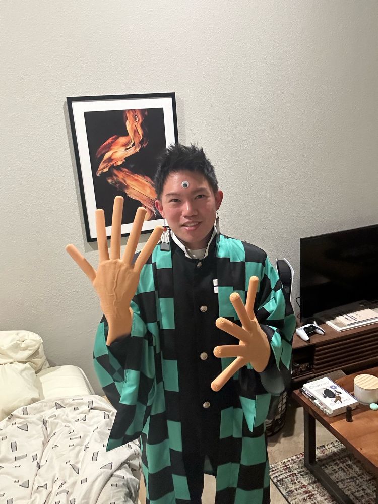 Tanjiro with googly eyes and hotdog fingers