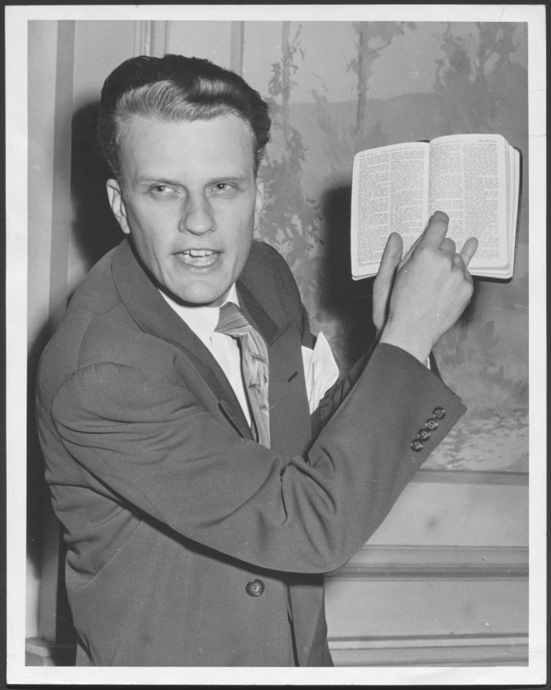 Billy Graham, in 1951, pointing at the Bible