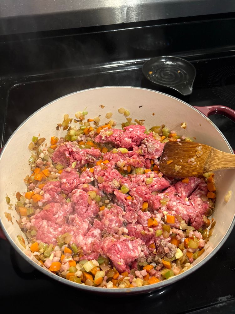 Layering flavor. Same pot as before - browning ground beef and sausage over high heat