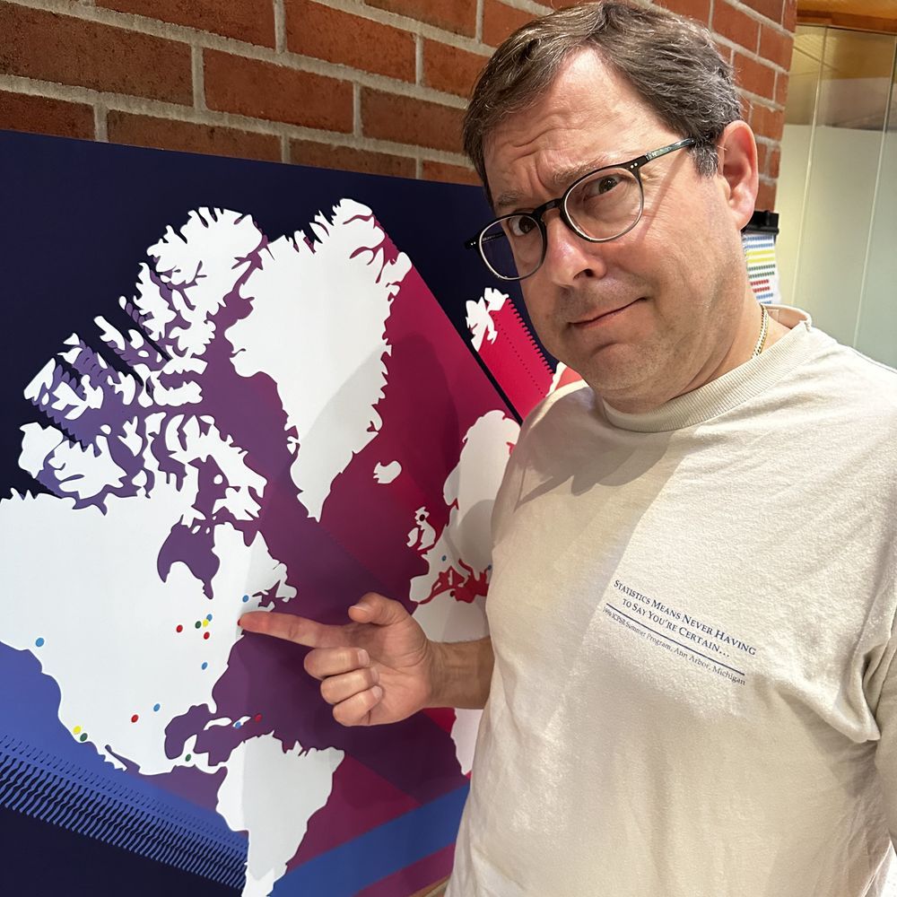 A confused man points to a michiganless world map