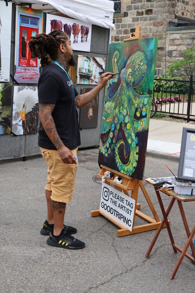 A man painting a green octopus.