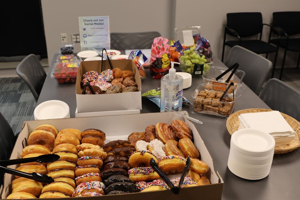 A spread of food, including various donuts and fruit
