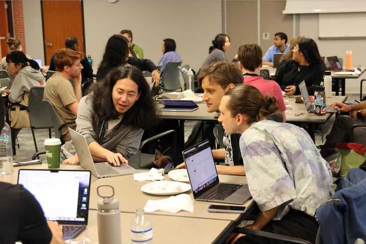 Participants looking at a computer screen.