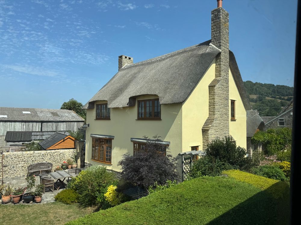 A thatched cottage with a distinctive yellow paint job on the outskirts of Seaton.