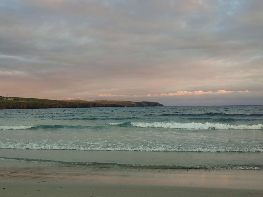 Sea with sunset in background 