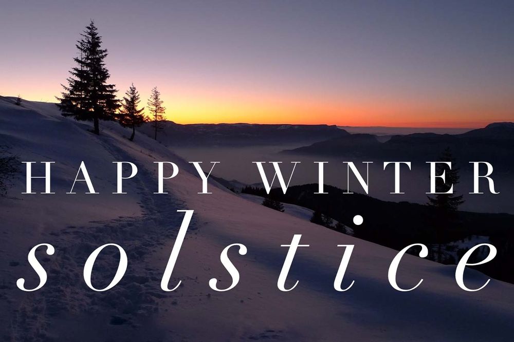 A picture of sunrise with winter snow and the words Happy Winter Solstice.