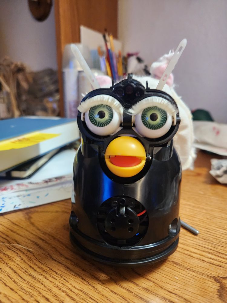 1998 snowball Furby with its skin off 