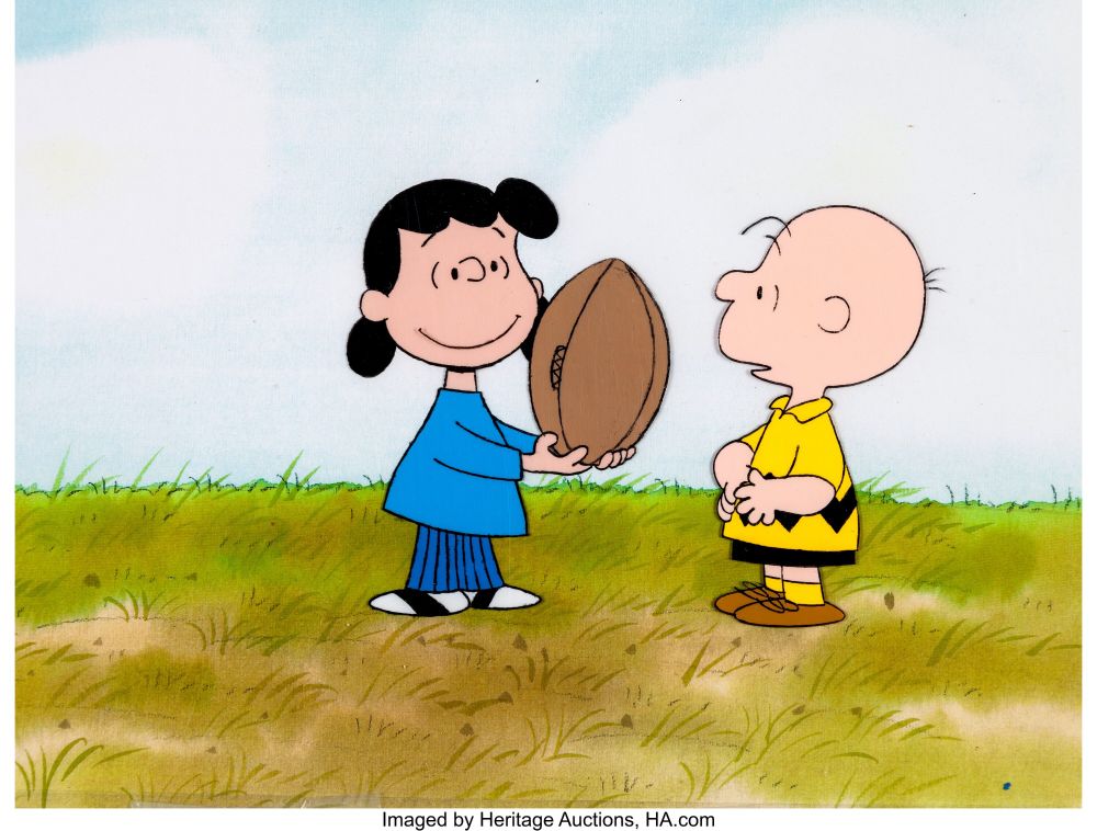 lucy offering a football to charlie brown