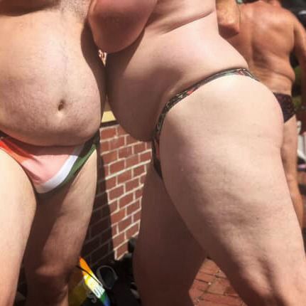 Close up of two guys in a speedo and a thong.