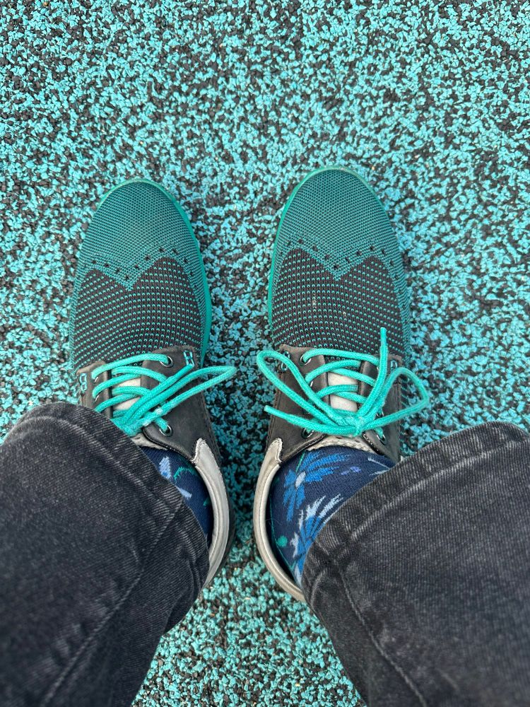 teal and black mesh faux wingtips on a teal and black speckled foam playground mat 