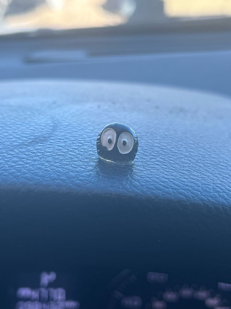 Tiny Ghibli soot sprite glued to my Subaru dashboard 