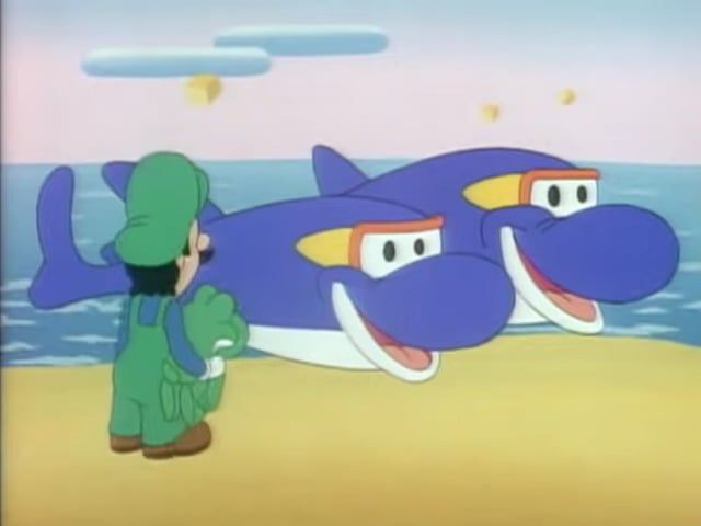 Screenshot from the Super Mario World cartoon that features Luigi and baby Yoshi looking at two dolphins who are both smiling and wearing goggles