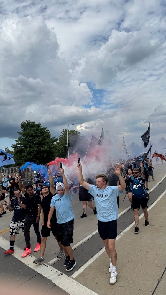 March leaders deploy red, white, and blue smoke to enliven festivities.