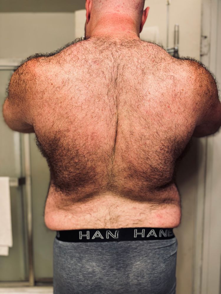 Furry bare back partially flexed. 