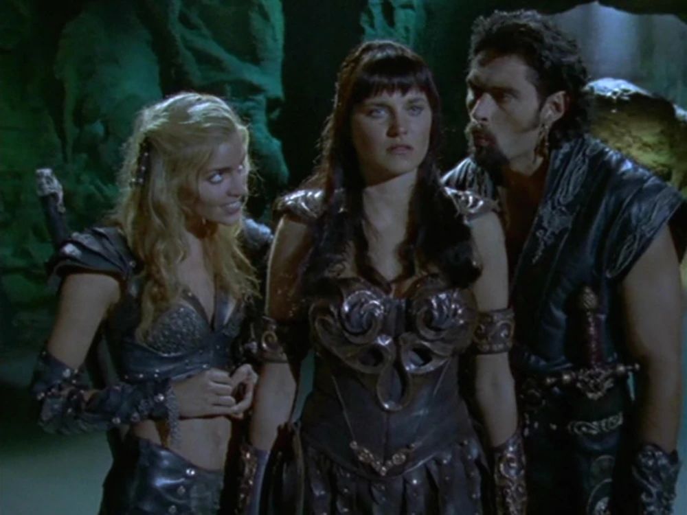 Still from Xena: Warrior Princess, an image of Callisto, Xena and Ares together.