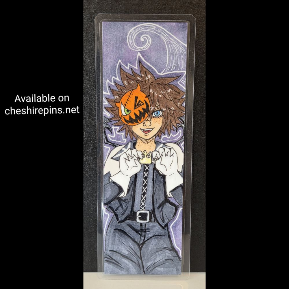 A bookmark of Sora from Kingdom Hearts, in his Halloweentown disguise. He's against a backdrop featuring spiral Hill, and is making a little growl clawing motion with his hands. 