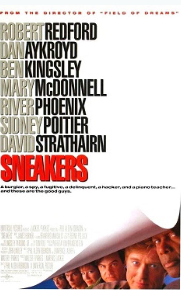A movie poster for the film “Sneakers” with Robert Redford, Dan Aykroyd, Ben Kingsley, Mary McDonnell, River Phoenix, Sidney Poitier and David Strathairn, showing the cast members peaking out from the lower right corner.
