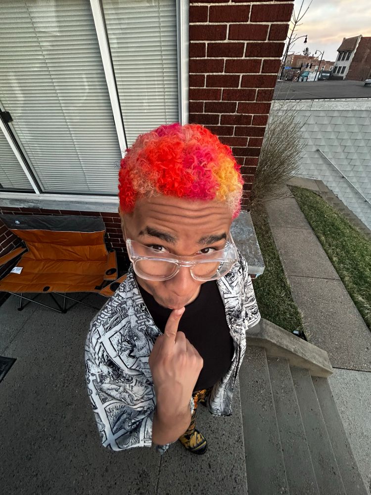 Me with newly cut curly 4B texture curls dyed like a heat map posing goofy 