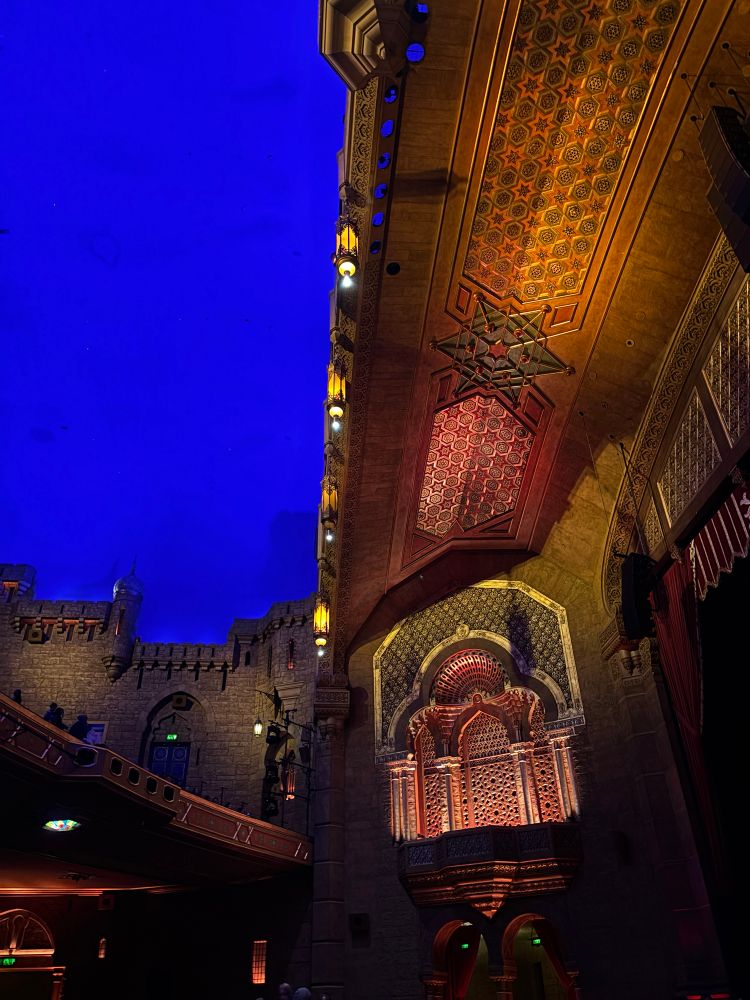 Overhead interior of Fox Theater with dark blue sky, and elaborately carved wooden details.  