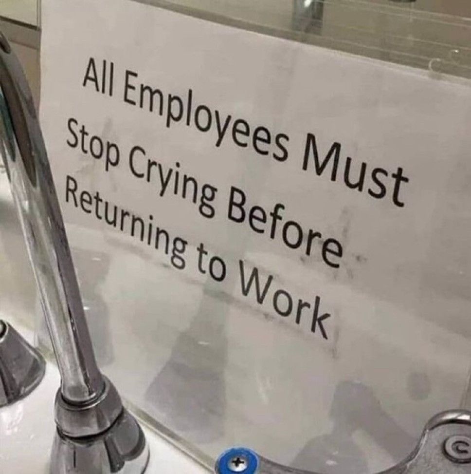 A laminated sign behind a sink reads,  "All Employees Must Stop Crying Before Returning to Work"