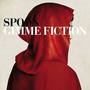 The cover of the Spoon album "Gimme Fiction" which is the back of a person wearing a red cloak. 
