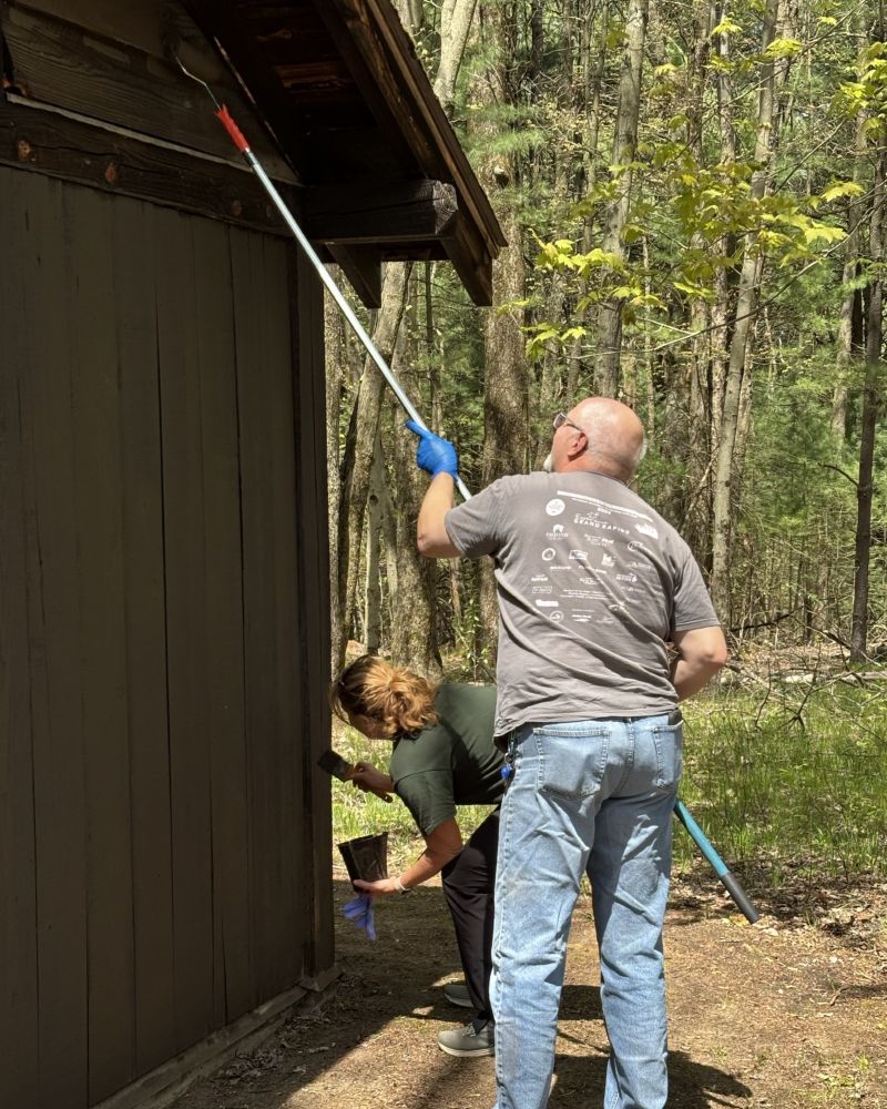 DNR staff paint a cabin at Yankee Springs Recreation Area. 