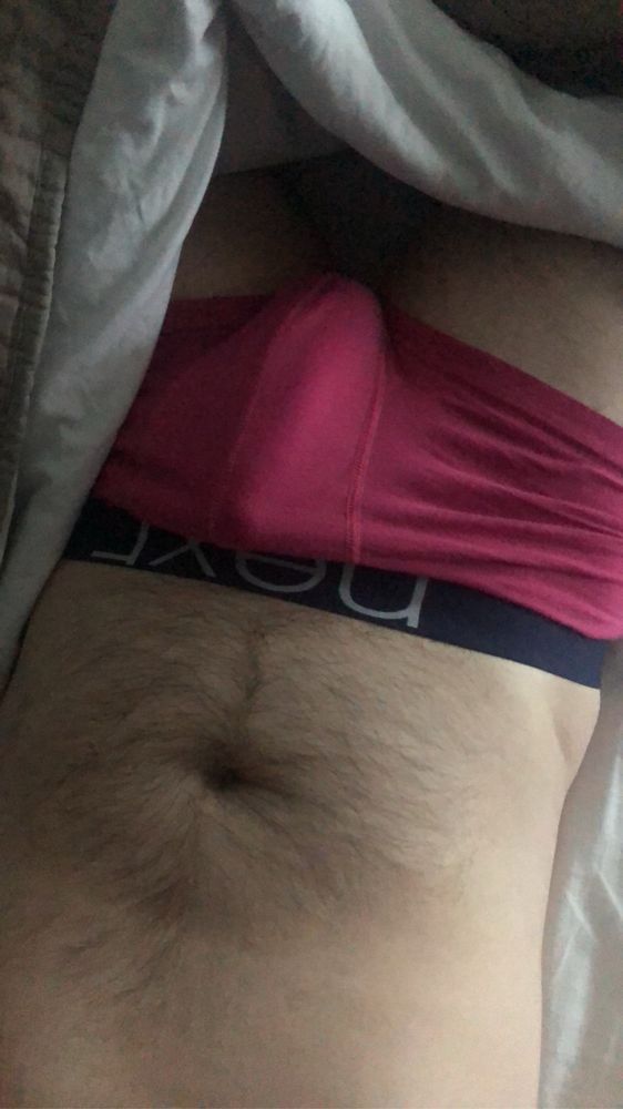 A semi flat tummy cause I’m laying down. With a cock starting to stretch out some pink underwear